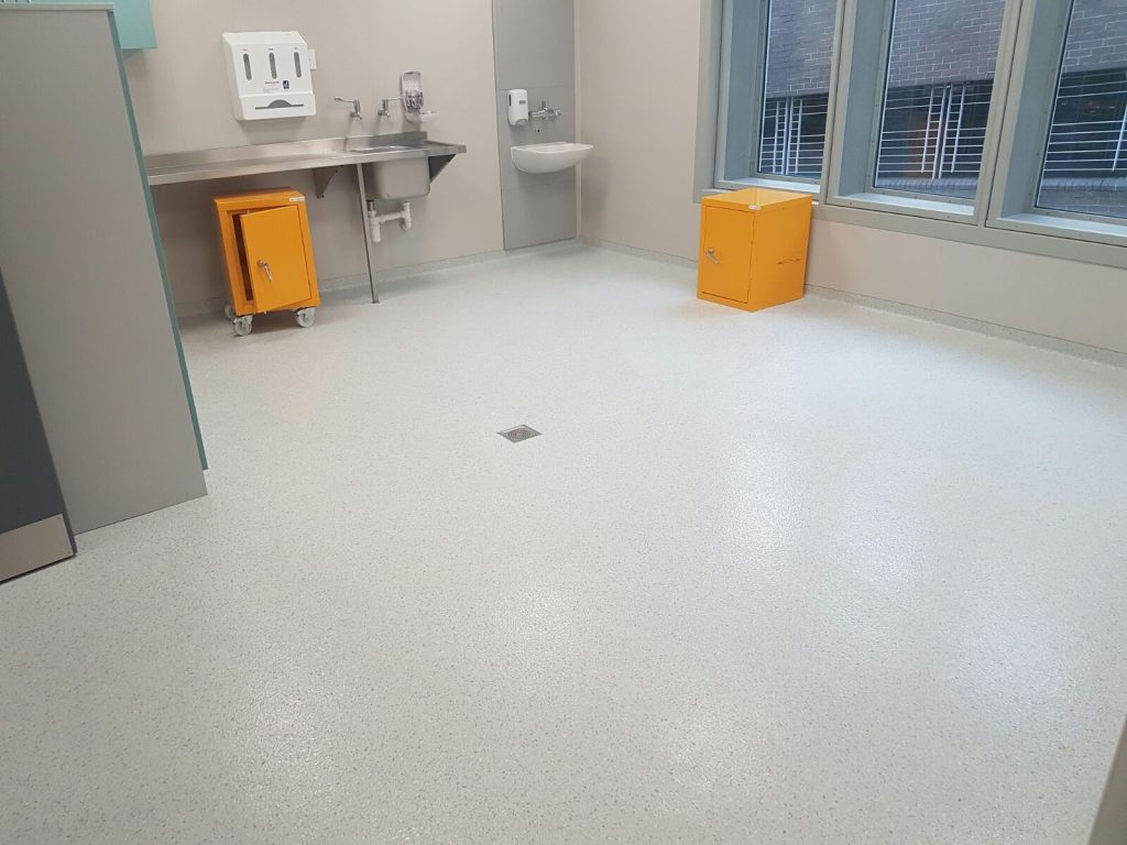 Epoxy decorative flake flooring with smooth, reflective finish
