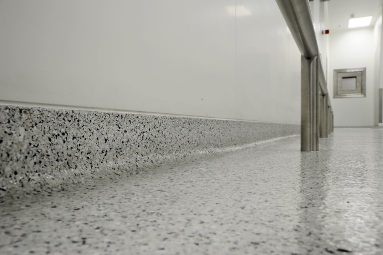 Smooth, seamless decorative flake flooring in high-traffic pharma area